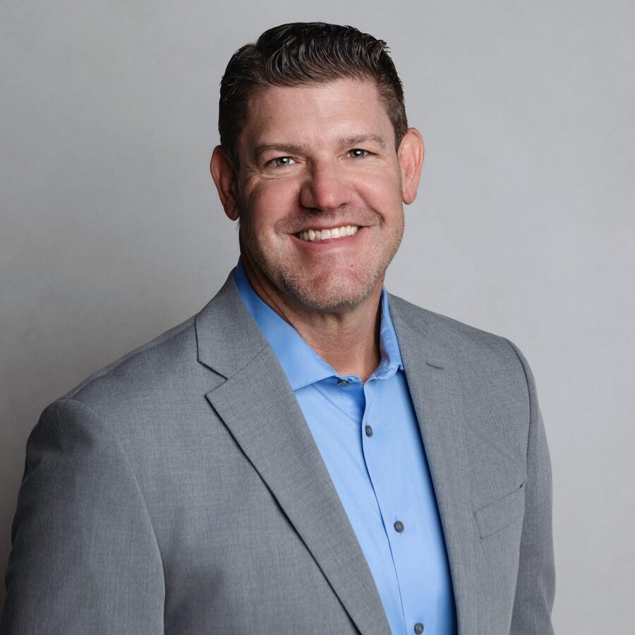 Gary Burmeister in a gray jacket and blue shirt.